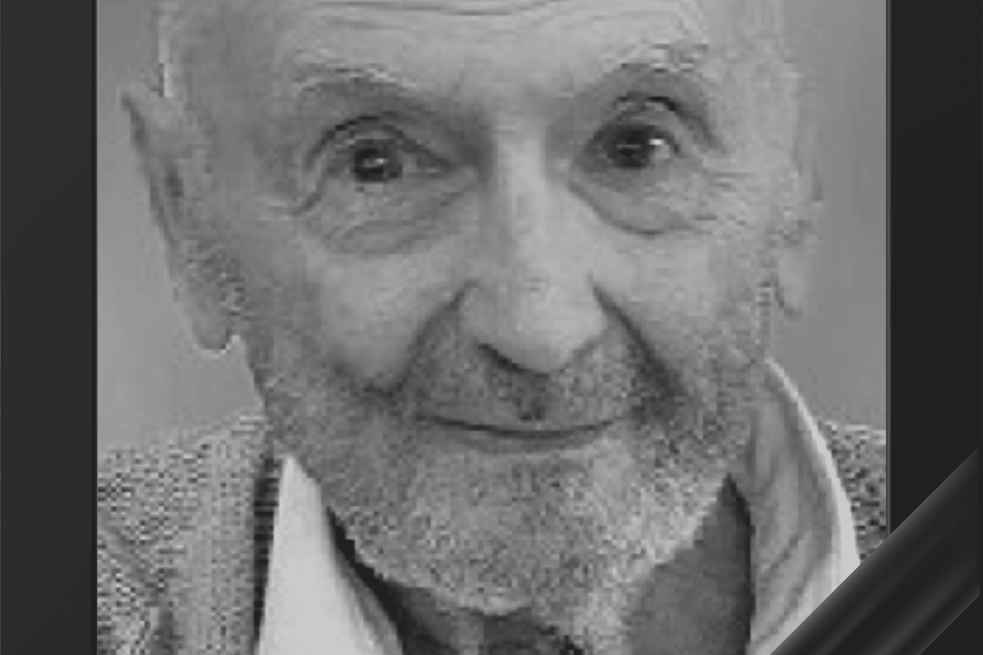 Portr&auml;t eines &auml;lteren Mannes mit Brille und Bart, umrahmt von einem schwarzen Trauerrand. Er l&auml;chelt freundlich.