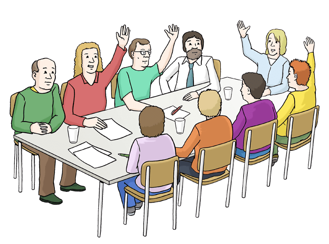 Neun Personen sitzen an einem Tisch und heben die H&auml;nde, w&auml;hrend sie an einer Besprechung teilnehmen.